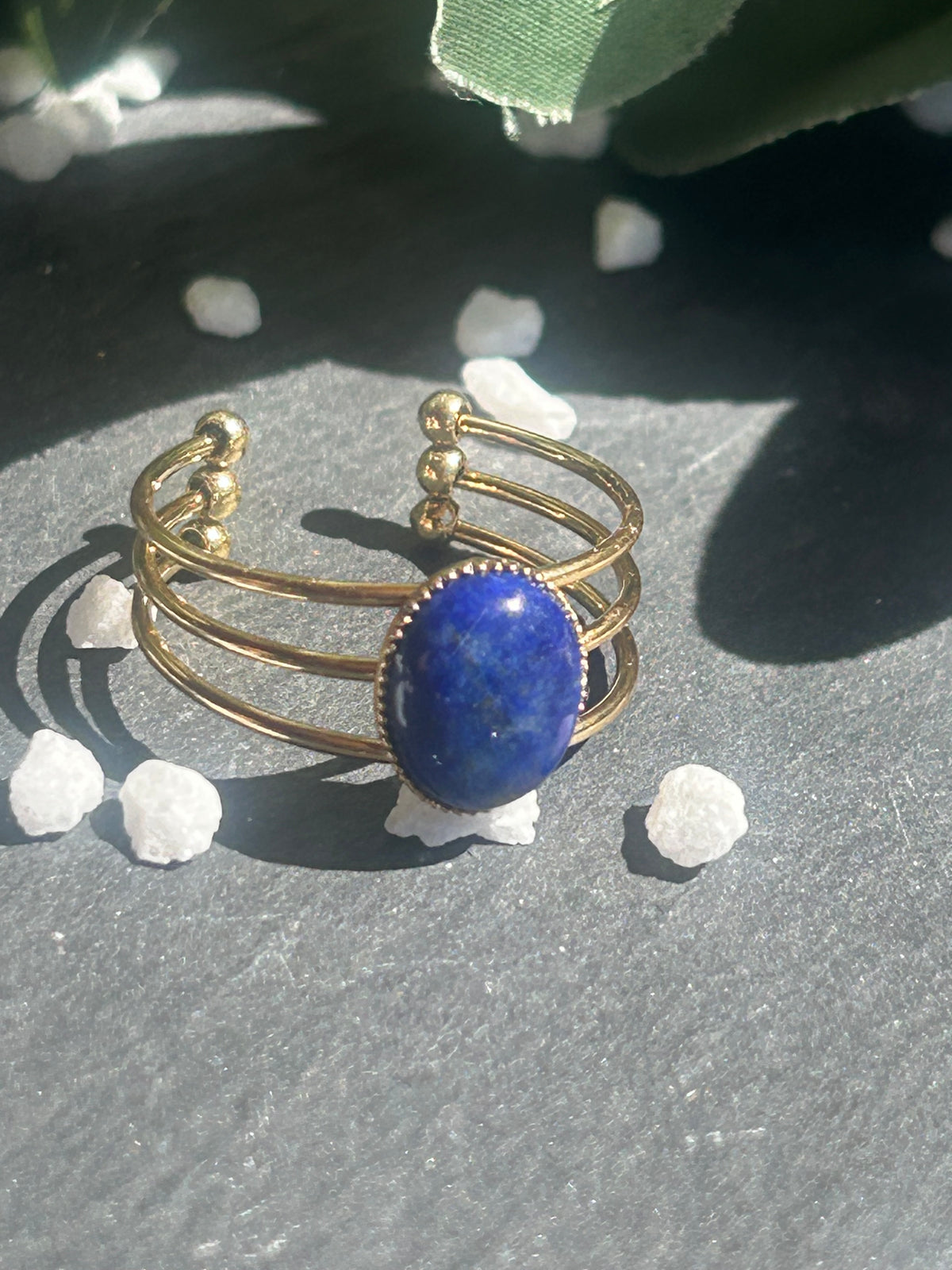 Bague Trinæa réglable à trois anneaux en acier inoxydable doré, ornée d’un lapis-lazuli bleu ovale.