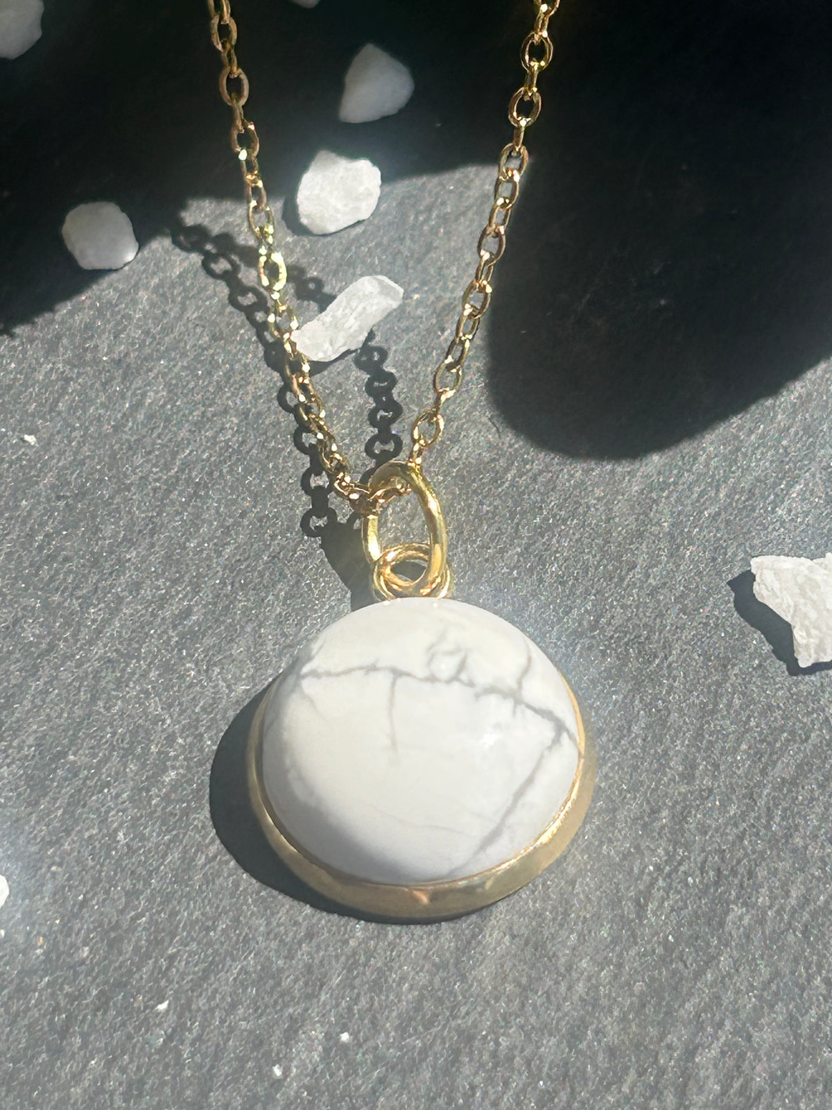 Collier Séléna en acier inoxydable doré, avec pendentif rond de 14 mm en howlite blanche veinée.
